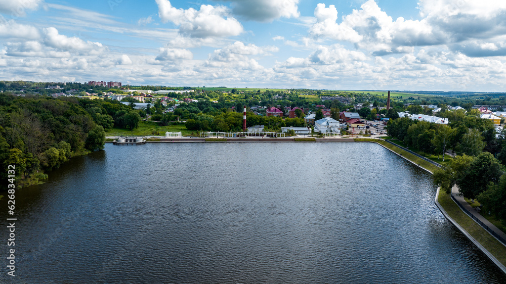 panoramic view of the white old stone manor on the shore of the lake and with the park in the city of Bogoroditsk