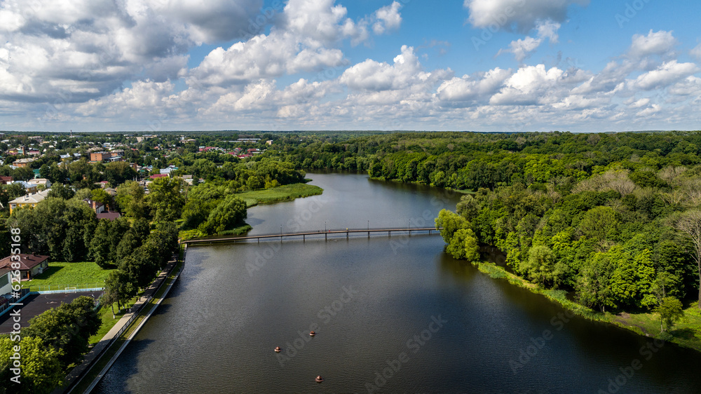 panoramic view of the white old stone manor on the shore of the lake and with the park in the city of Bogoroditsk