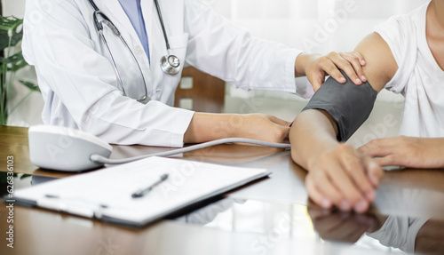 The female doctor measured blood pressure, the patient examined the heartbeat, and sat down to talk about health care closely. health care concept