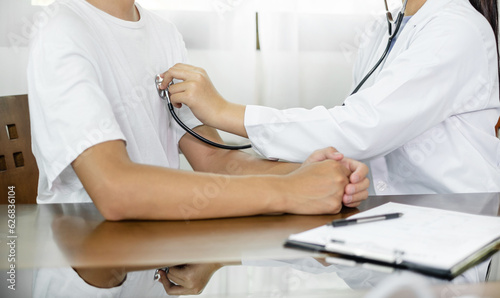 The female doctor measured blood pressure, the patient examined the heartbeat, and sat down to talk about health care closely. health care concept