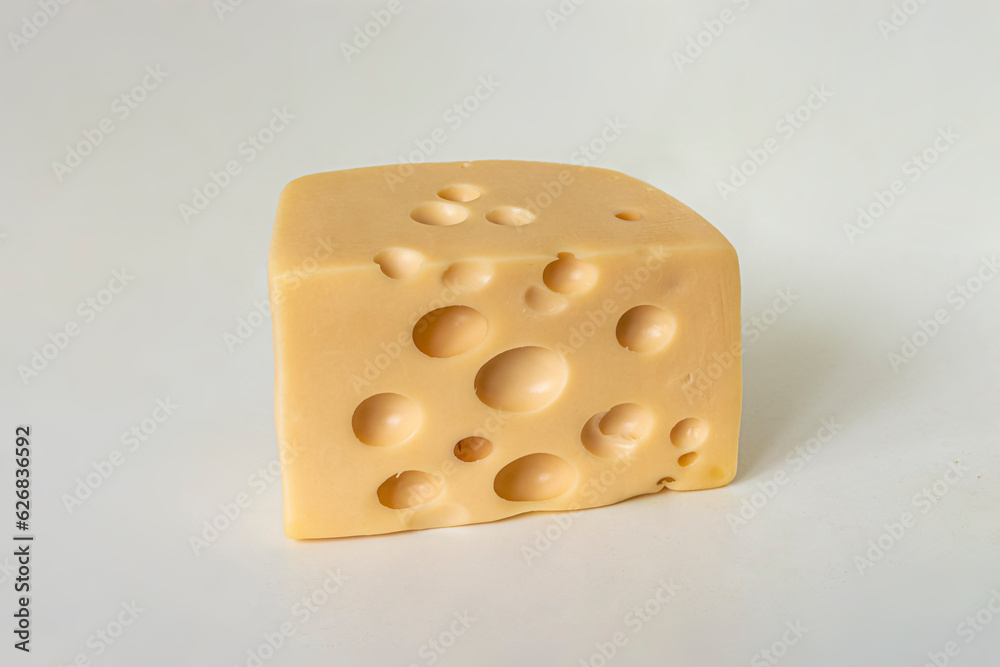 Piece of maasdam cheese with big holes