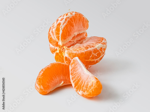 Peeled tangerine slices on a light background