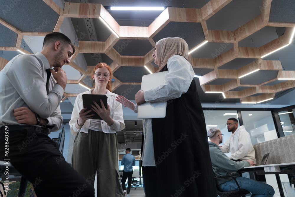 Young group of business people brainstorming together in a startup space, discussing business projects, investments, and solving challenges. Young group of business people brainstorming together in a startup space, discussing business projects, investments, and solving challenges.