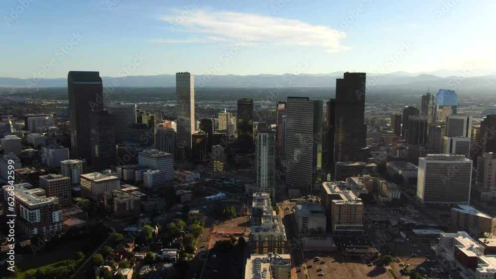 Aerial cinematic drone mid summer early fall Downtown Denver Colorado mile hight city buildings traffic wisp clouds blue sky afternoon sunset stunning golden hour light circling pan to the left motion Aerial cinematic drone mid summer early fall Downtown Denver Colorado mile hight city buildings traffic wisp clouds blue sky afternoon sunset stunning golden hour light circling pan to the left motion