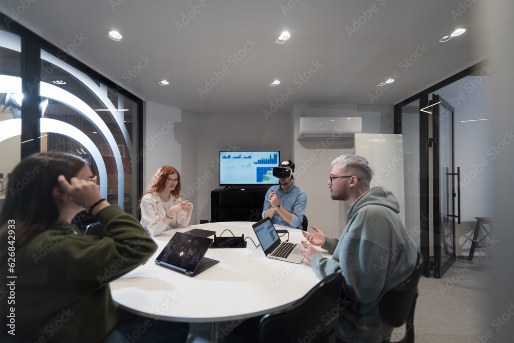 Foto de A diverse group of businessmen collaborates and tests a new ...