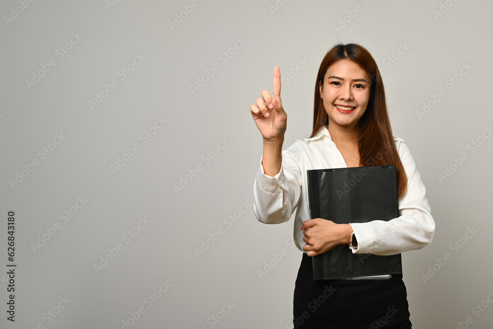 Beautiful asian woman office worker finger empty space isolated on gray background Beautiful asian woman office worker finger empty space isolated on gray background