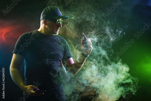 Man smokes vape. Guy with e...