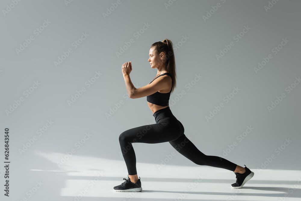 fit brunette sportswoman in black sports bra and leggings doing lunges active lifestyle concept fit brunette sportswoman in black sports bra and leggings doing lunges active lifestyle concept