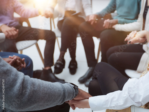 close-up of a business team sitting holding hands