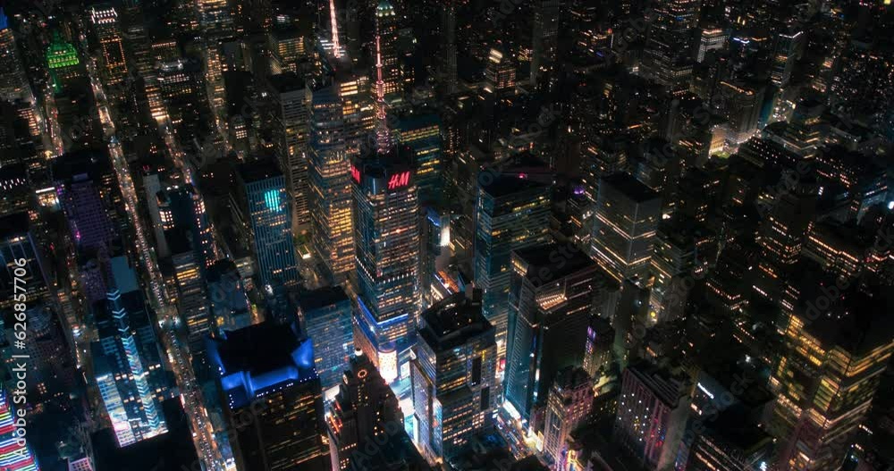 New York Concrete Jungle in the Evening. Aerial Footage from a Helicopter Tour Around the Big Apple. Scenes with Modern Skyscraper Buildings Around the Entertainment District and Times Square
