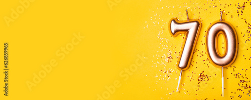 70 years celebration. Greeting banner. Gold candles in the form of number forty on yellow background with confetti. photo