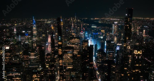 New York City Aerial Skyline with Historic and Modern Manhattan Skyscrapers and Residential Buildings at Night. Scenic Helicopter View of Popular Tourist and Business Attractions in the Dark