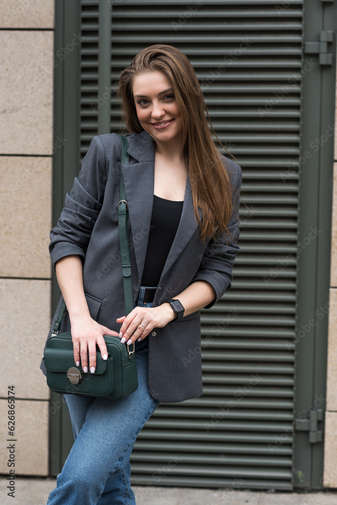 Portrait of a happy smiling woman in casual clothes while walking around the city. Portrait of a happy smiling woman in casual clothes while walking around the city.