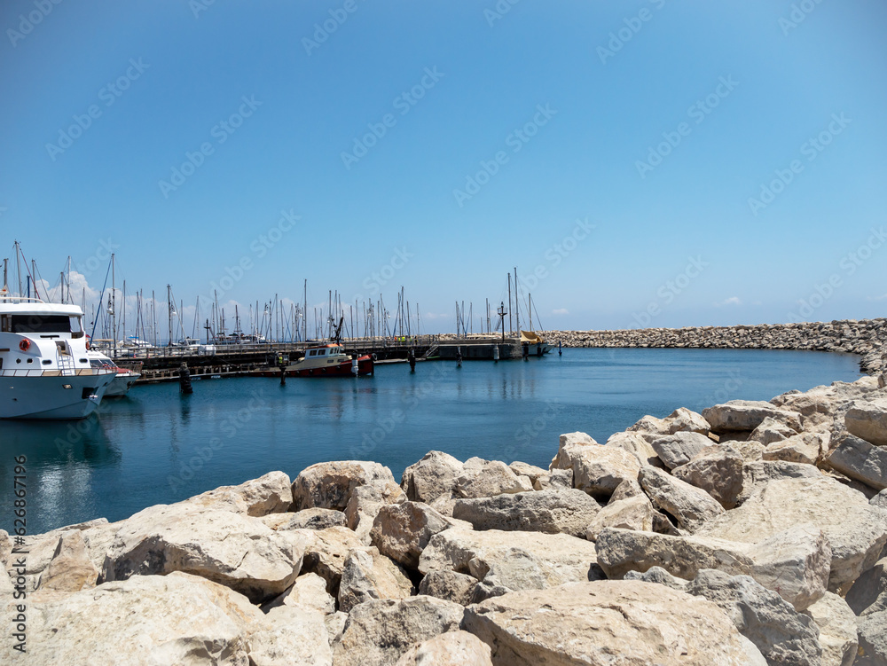 Ships on the dock with rocks in the foreground