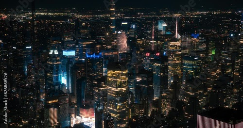 Helicopter Tour of New York Cityscape at Night. Fly-By Over Manhattan with Panorama of Office Buildings with Lights and Congested Streets with Cars and Taxi Vehicles in a Big City