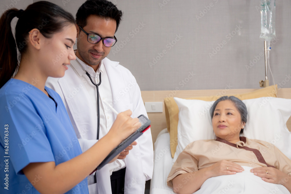 Specialist doctor and nurse explaining and check with elderly patient in hospital, medical and sick, diagnostic with report medical and health care on tablet, examining disease, senior and unwell. Specialist doctor and nurse explaining and check with elderly patient in hospital, medical and sick, diagnostic with report medical and health care on tablet, examining disease, senior and unwell.