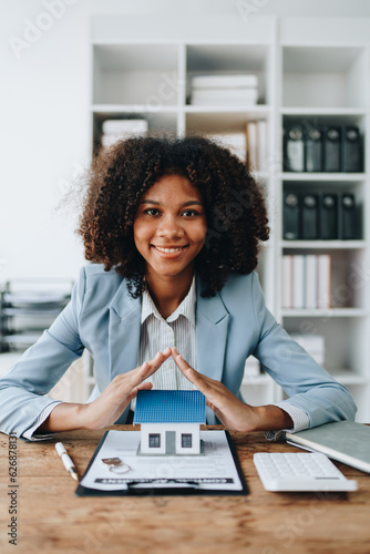Real estate african american, Agent, buy and sell land, property tax, show the concept of protecting the house to insure the risk of damage to the home. insurance concepts