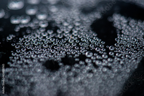 Water droplets on a black background. Macro. Shallow depth of field.