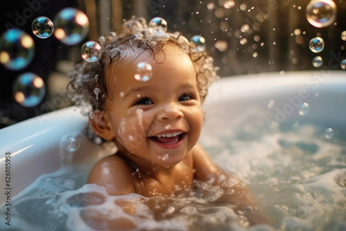 Portrait of happy smiling satisfied black kid taking a bath with foam and soap bubbles