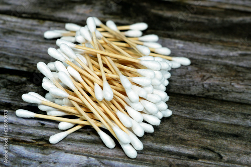 Pile of ear cotton swab buds sticks, for health care, ideal for gently cleaning around the outer surface of the ear, and a variety of beauty and personal care uses, cotton swabs, selective focus photo