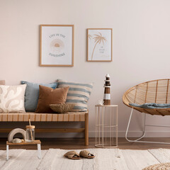 Interior design of cozy and summer living room with rattan armchair, couch, pillows, mock u poster frame, side table, bamboo ladder, decoration, carpet and personal accessories. Stylish home decor.