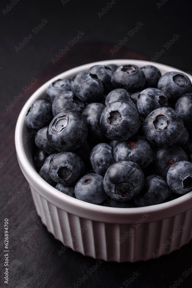 Delicious fresh sweet blueberries in a ceramic bowl. Vegan food Delicious fresh sweet blueberries in a ceramic bowl. Vegan food
