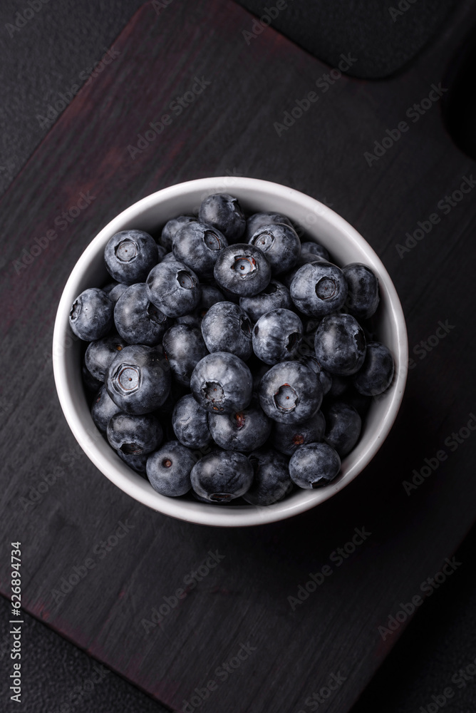 Delicious fresh sweet blueberries in a ceramic bowl. Vegan food Delicious fresh sweet blueberries in a ceramic bowl. Vegan food