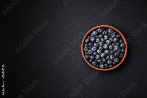 Fotografija Delicious fresh sweet blueberries in a ceramic bowl. Vegan food
