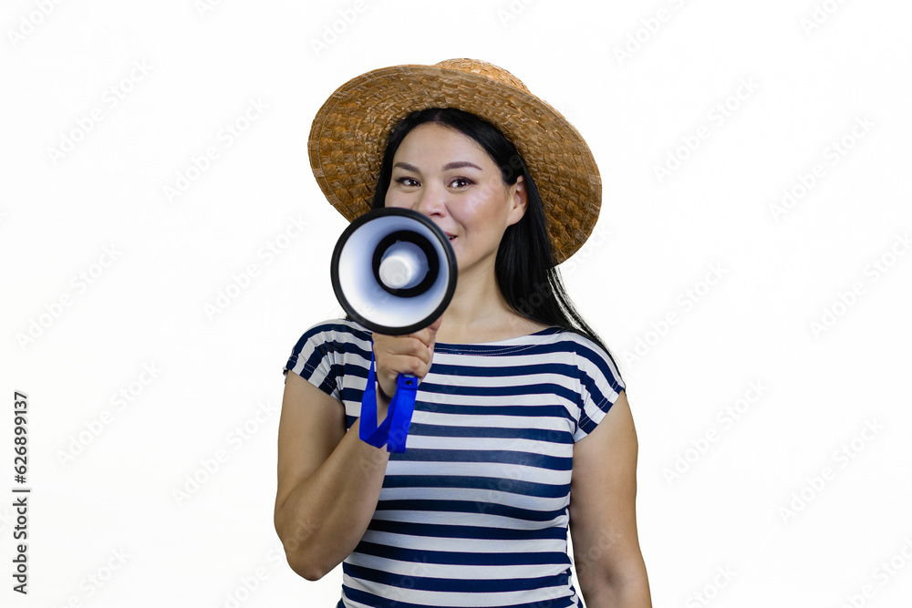 Fototapeta premium Young asian woman in a brim straw hat is announcing something in megaphone. Isolated on white.