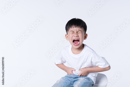 Asian boy touching his belly from stomach pain symptom © bonnontawat