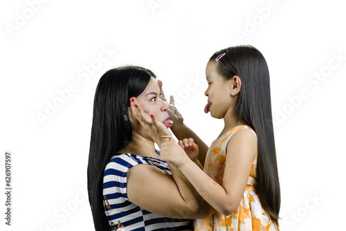 Brunette mother and daughter fooling around and showing each other their tongues. Isolated on white.
