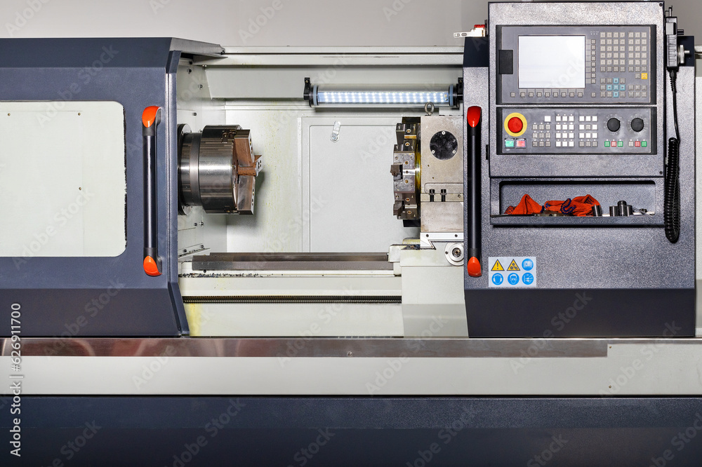 Industrial CNC lathe with control panel. Close-up. Copy space.