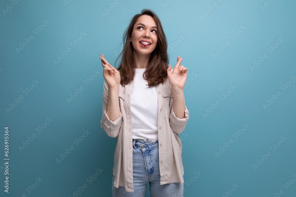 stylish dreamy 30 year old female person in elegant look smiling on blue background stylish dreamy 30 year old female person in elegant look smiling on blue background