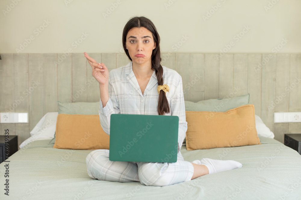 pretty young model crossing fingers and hoping for good luck. rest and nightwear concept pretty young model crossing fingers and hoping for good luck. rest and nightwear concept