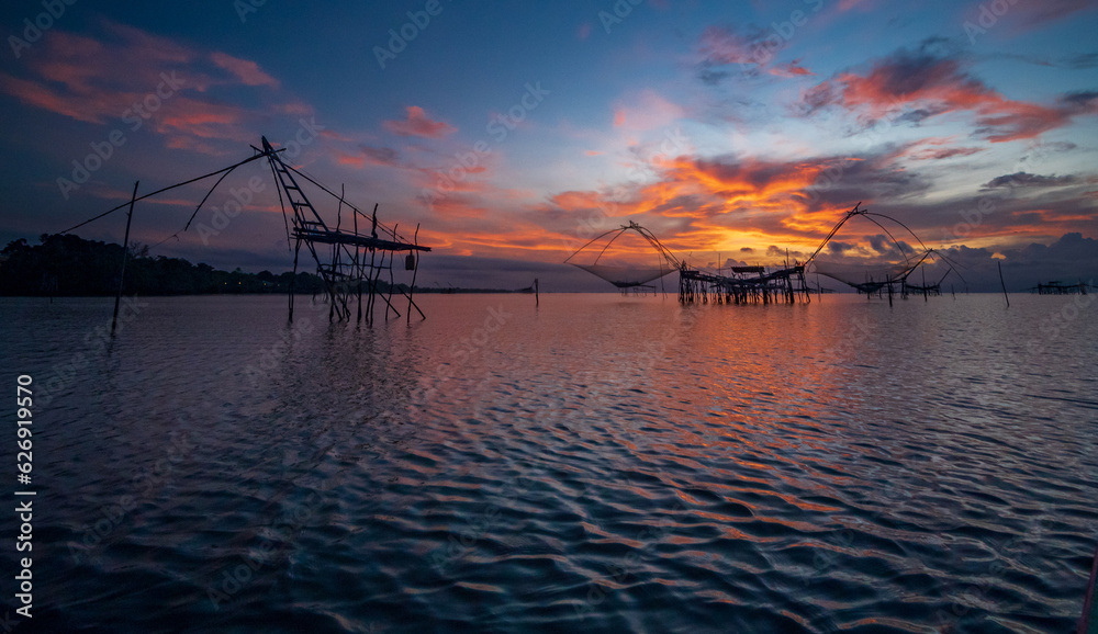 Phatthalung Thailand, Landscape front view atmosphere of cruising on the lake in the morning day dawn and sunset golden light, with the fishing local fisherman mornings. Phatthalung Thailand, Landscape front view atmosphere of cruising on the lake in the morning day dawn and sunset golden light, with the fishing local fisherman mornings.