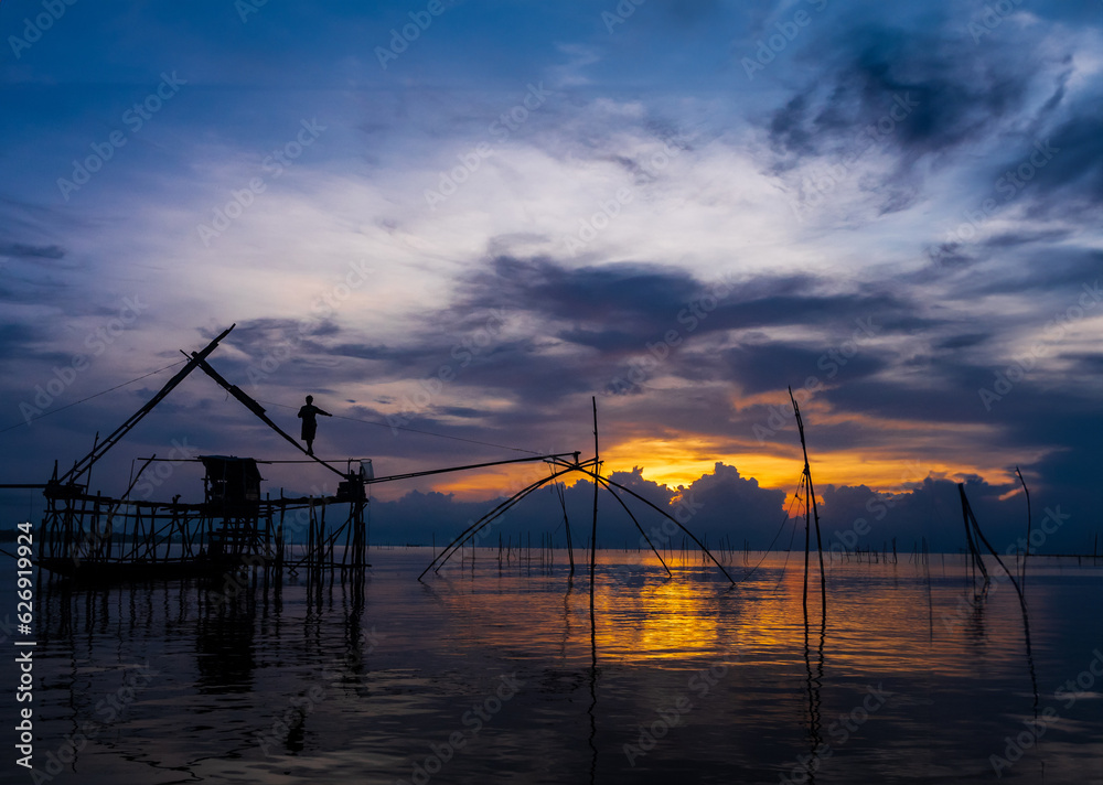 Phatthalung Thailand, Landscape front view atmosphere of cruising on the lake in the morning day  dawn and sunset golden light, with the fishing  local fisherman mornings.