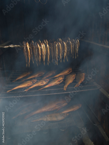 smoking fish in a wooden smokehouse.