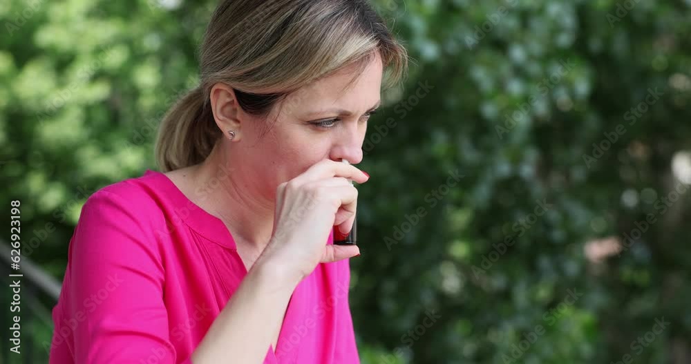 Nasal drops and pollen allergies in spring and summer. Woman using nasal spray Nasal drops and pollen allergies in spring and summer. Woman using nasal spray