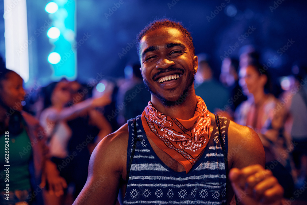 Happy black man dancing at open air music concert at night and looking at camera. Happy black man dancing at open air music concert at night and looking at camera.