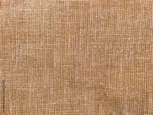 Woven synthetic jute carpet backing pattern as background photo