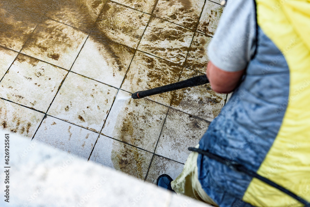 Swimming pool cleaning. A service man is cleaning the pool ground with a high-pressure washer. Swimming pool cleaning. A service man is cleaning the pool ground with a high-pressure washer.