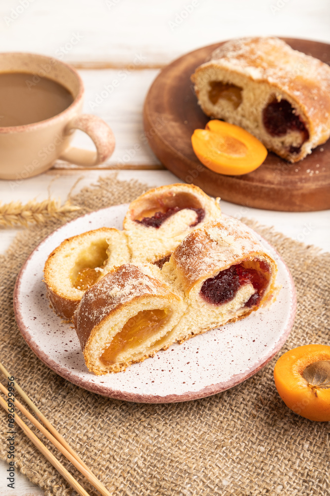 Homemade sweet bun with apricot jam on white wooden. side view. Homemade sweet bun with apricot jam on white wooden. side view.