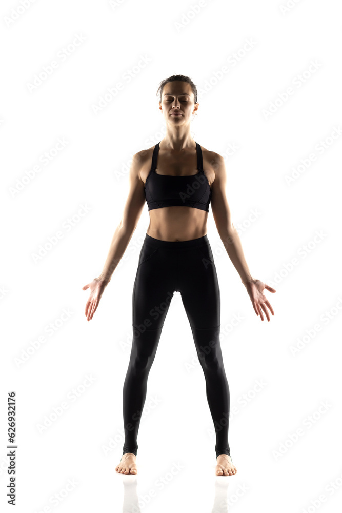 Portrait of young beautiful woman in black sportswear doing yoga practice Portrait of young beautiful woman in black sportswear doing yoga practice