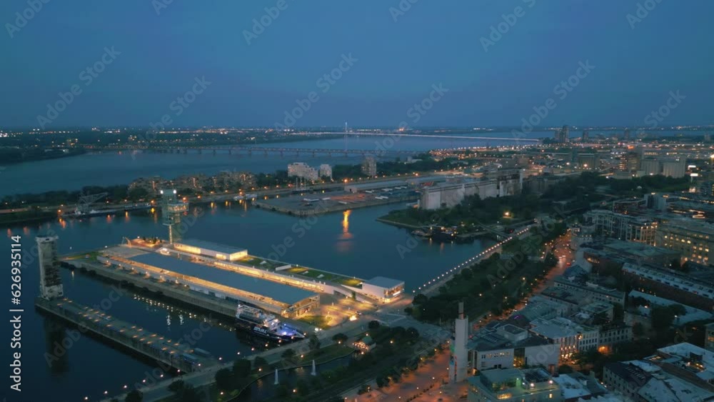 Late afternoon sundown pan over Montreal old port area filled with lights overlooking stacked container container houses Late afternoon sundown pan over Montreal old port area filled with lights overlooking stacked container container houses