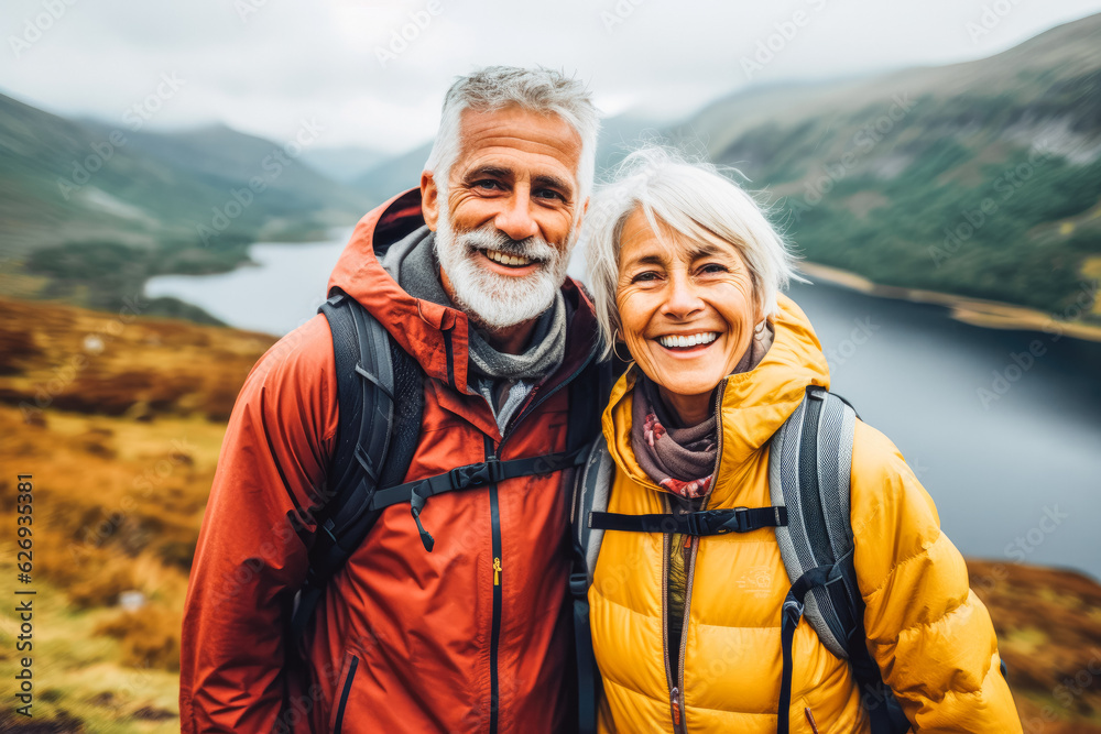 Multiethnic couple traveling in Scotland in summer. Happy older travelers exploring in nature.