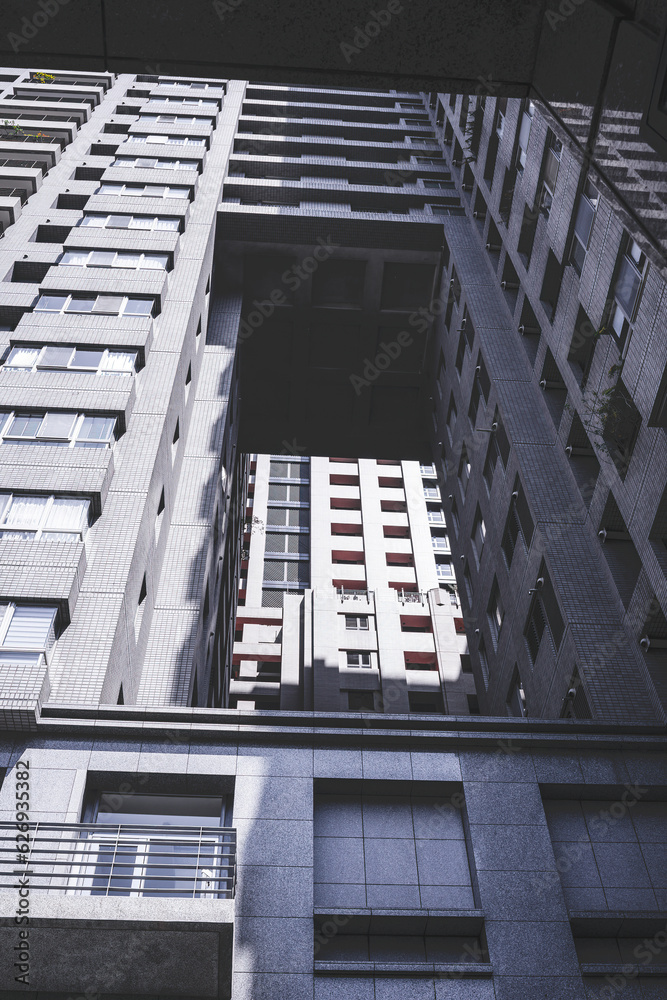 Vertical format background image of a modern gray high-rise building with many windows. Vertical format background image of a modern gray high-rise building with many windows.