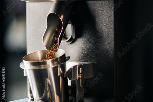 Tableau sur toile cafe equipment, ground coffee pouring from electric coffee grinder into measurin