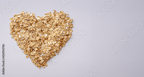 Oat flakes forming heart shape on white background,Top view and copy space