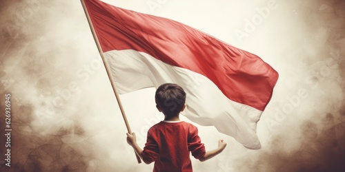 Little boy is bringing a Red White flag of Indonesia. Little boy holding the Indonesian flag, Indonesia independence day