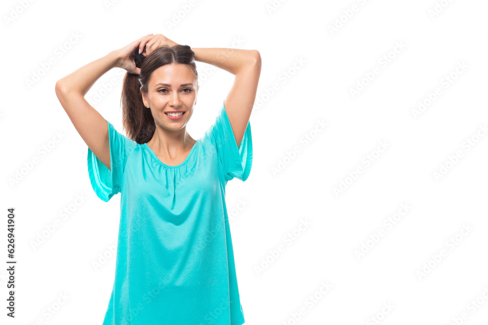 portrait of a pretty young caucasian brunette woman in a blue t-shirt on a white background with copy space portrait of a pretty young caucasian brunette woman in a blue t-shirt on a white background with copy space